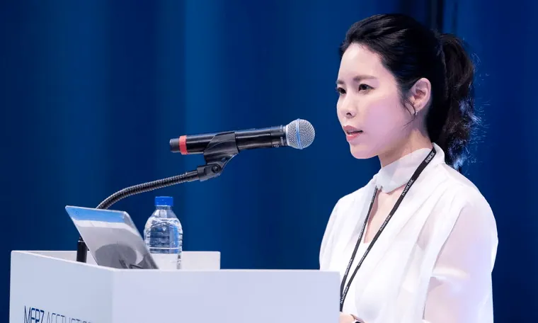 Dr. Yu at the Merz Aesthetics congress podium